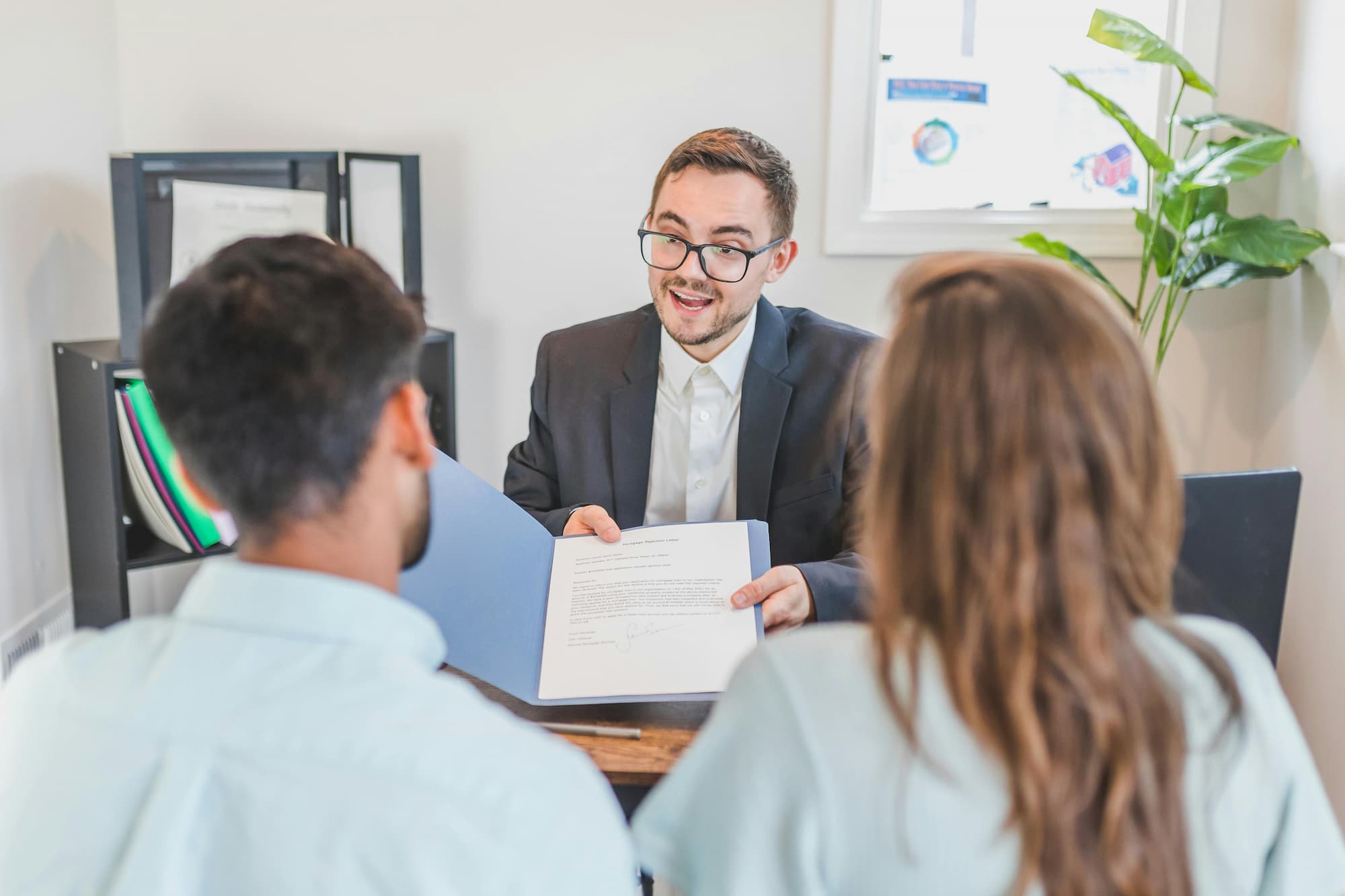Image of a business team reviewing a global contract, symbolizing cross-border compliance